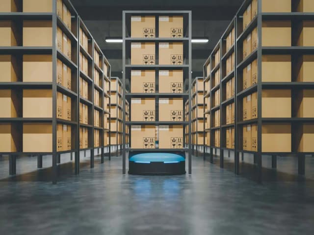 Automated warehouse with robotic AGV delivering boxes between storage shelves
