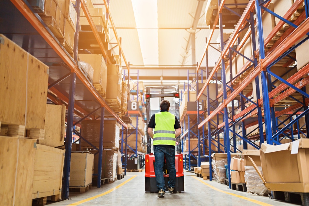 male worker operating warehousing machinery