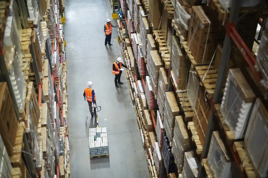 overhead view of workers doing warehouse inventory replenishment