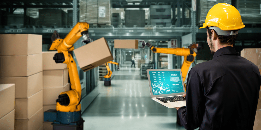 Warehouse-with-automation-bots-and-worker-using-wms-software