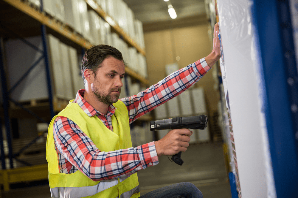 Man-in-warehouse-scanning-inventory