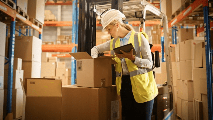 warehouse worker checking inventory in boxes