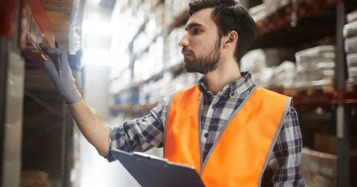warehouse worker looking at a location barcode label on warehouse racking