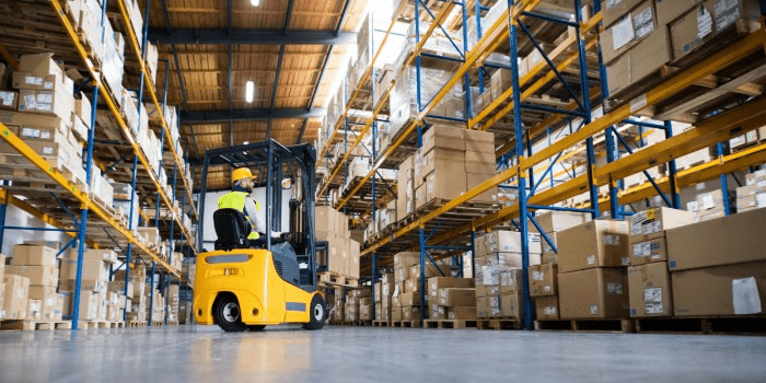 forklift moving boxes in a warehouse