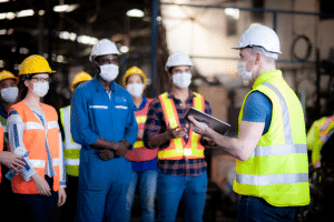 warehouse safety meeting with staff waring PPE