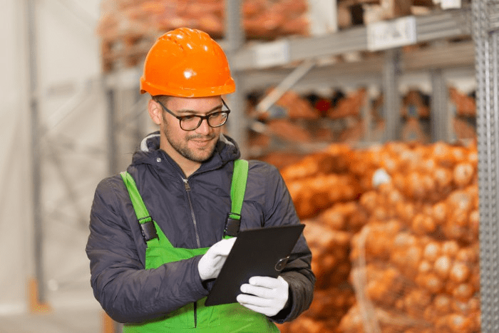 warehouse worker with a tablet in a food warehouse