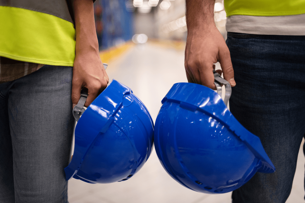 Two-warehouse-employees-with-safety-helmets-and-attire