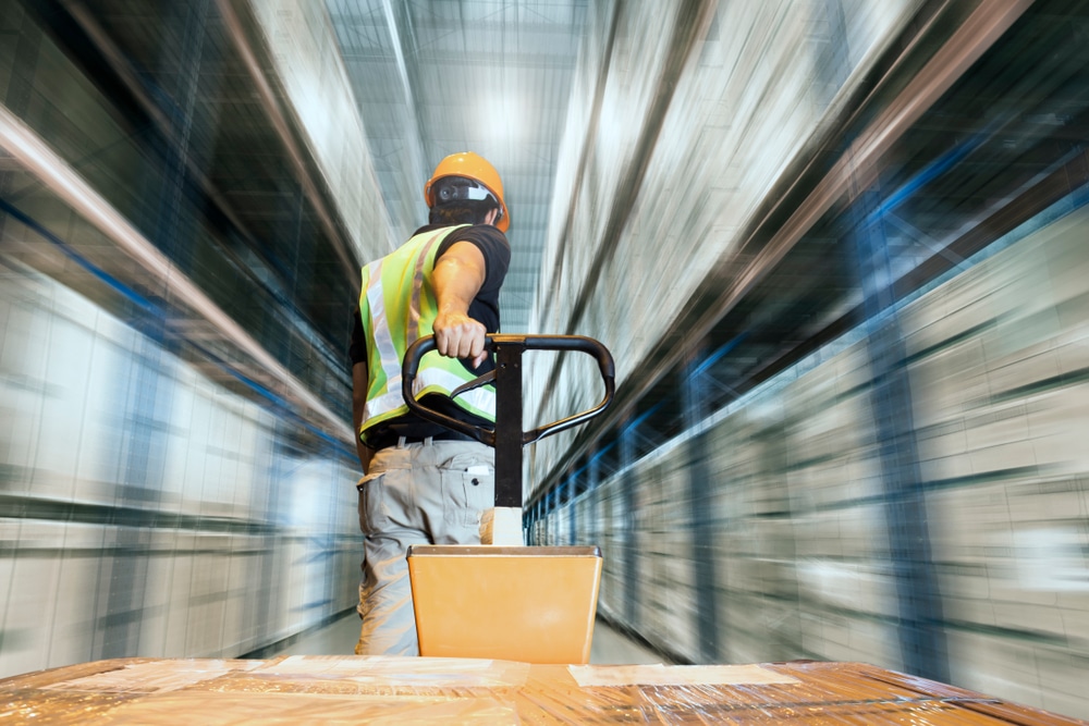 image of warehouse efficiency worker pulling pallet