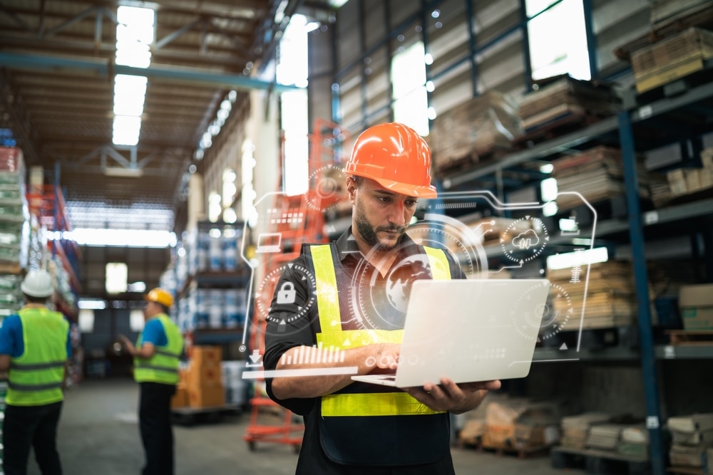 man looking at warehouse visibility software on laptop