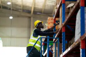 product putaway - warehouse worker putting an item on the shelf