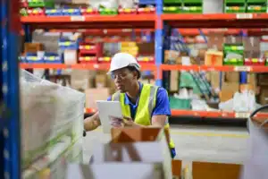 warehouse worker checking inventory to confirm counts