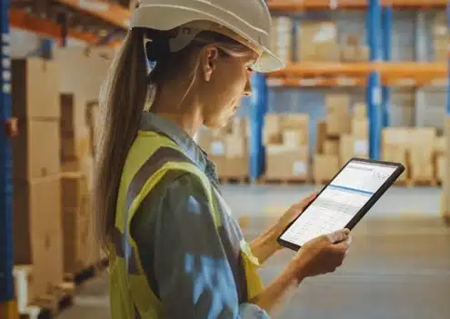 warehouse worker looking at a tablet