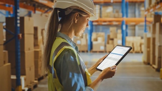 warehouse worker looking at a tablet