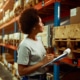 woman looking at the shelves with a clipboard