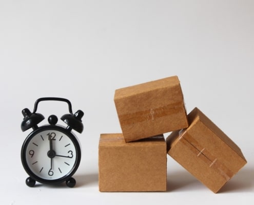 alarm clock next to a pile of boxes