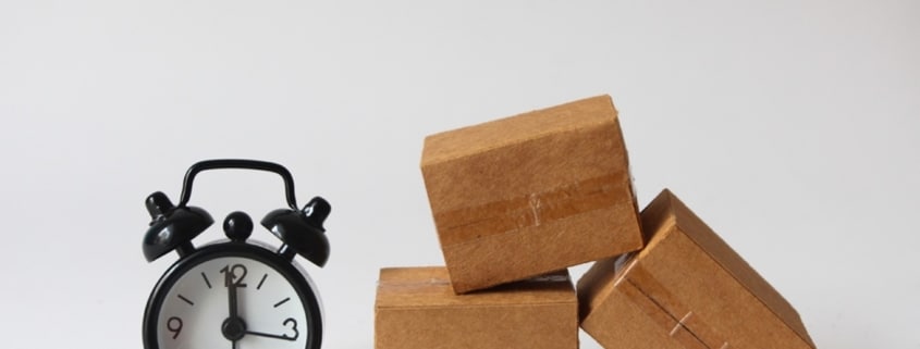 alarm clock next to a pile of boxes