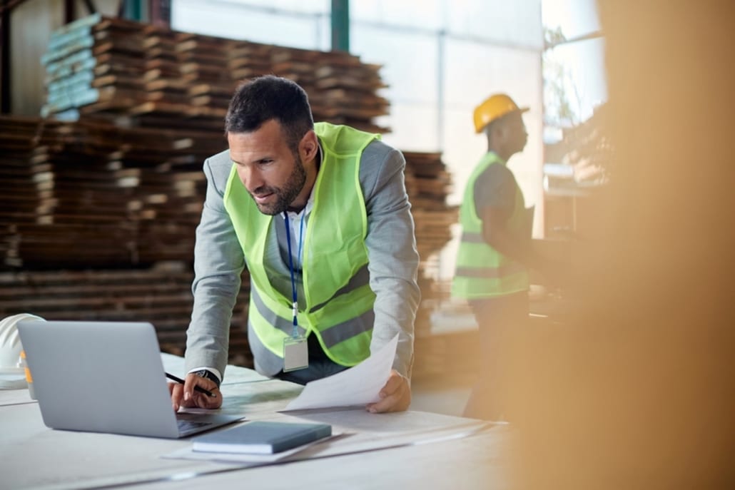 warehouse worker looking at his laptop