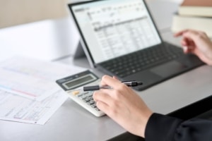 woman-using-accounting-software-and-calculator