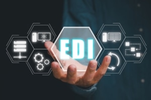 a person holding a block with EDI in it surrounded by process icons