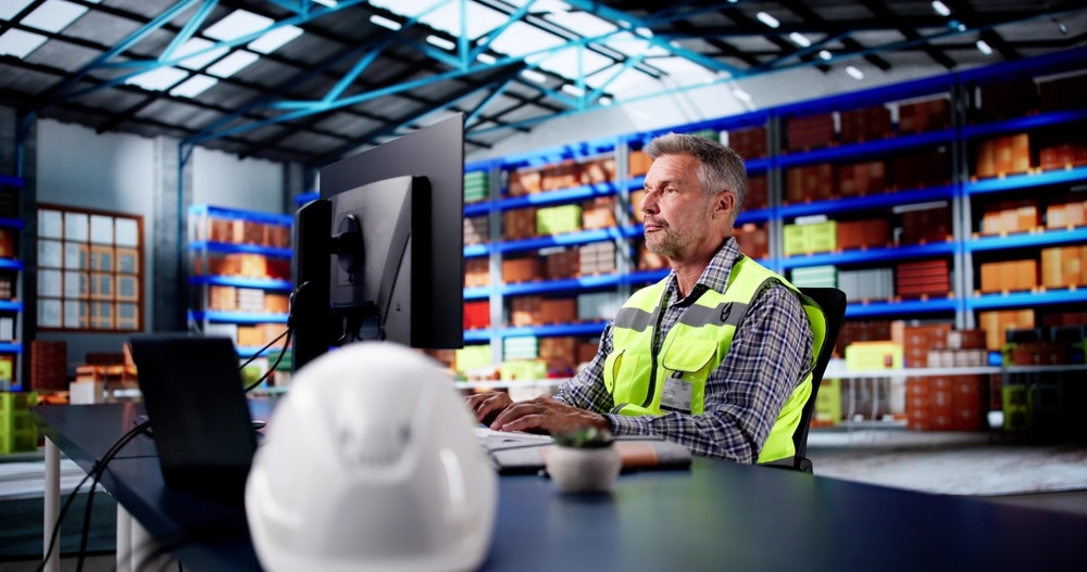 manager creating warehouse sops on computer