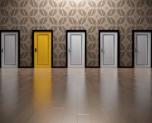 Seven doors in hallway with one yellow door representing business software choice decisions