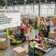 Holiday product sellers checklist in a bustling warehouse preparing for the season.