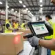 Cadence WMS warehouse management software showing worker scanning boxes in distribution center