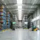 Large warehouse with blue pallet racking systems storing inventory for just-in-time management