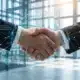Business handshake with digital network overlay representing strategic technology partnership