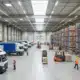 showing warehouse actions: trucks, warehouses, shelving, forklift