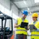 Two-warehouse-employees-with-safety-helmets-and-attire