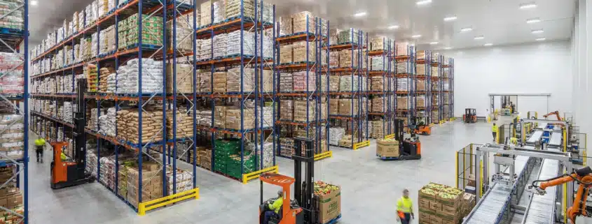 Modern food warehouse with organized inventory shelving and forklift equipment