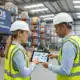 Two professionals in hard hats reviewing warehouse operations for Axis Global case study