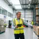 Warehouse manager with tablet reviewing inventory in bonded logistics facility