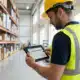 warehouse worker looking at a tablet