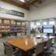 Modern warehouse conference room with Policy & Procedures sign and inventory shelves
