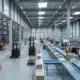 Modern 3PL warehouse with robotic forklifts and IoT-enabled conveyor systems managing diverse inventory.