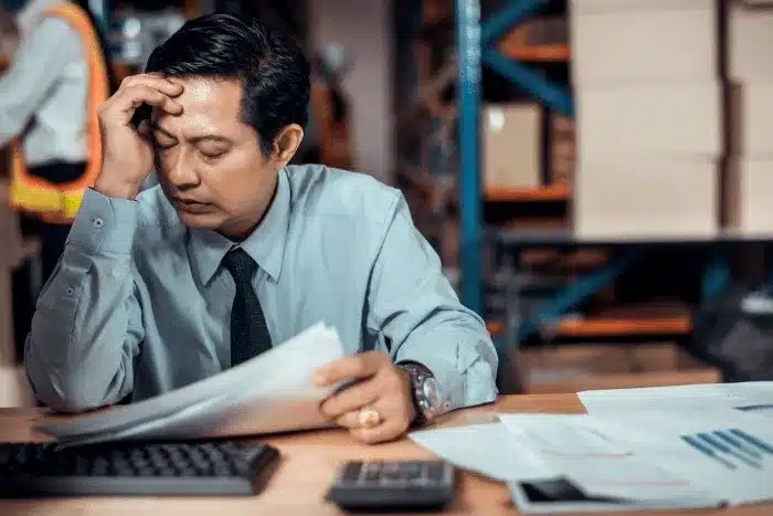 someone reviewing papers with a frustrated look