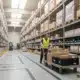 Wide warehouse aisle with worker and shelving