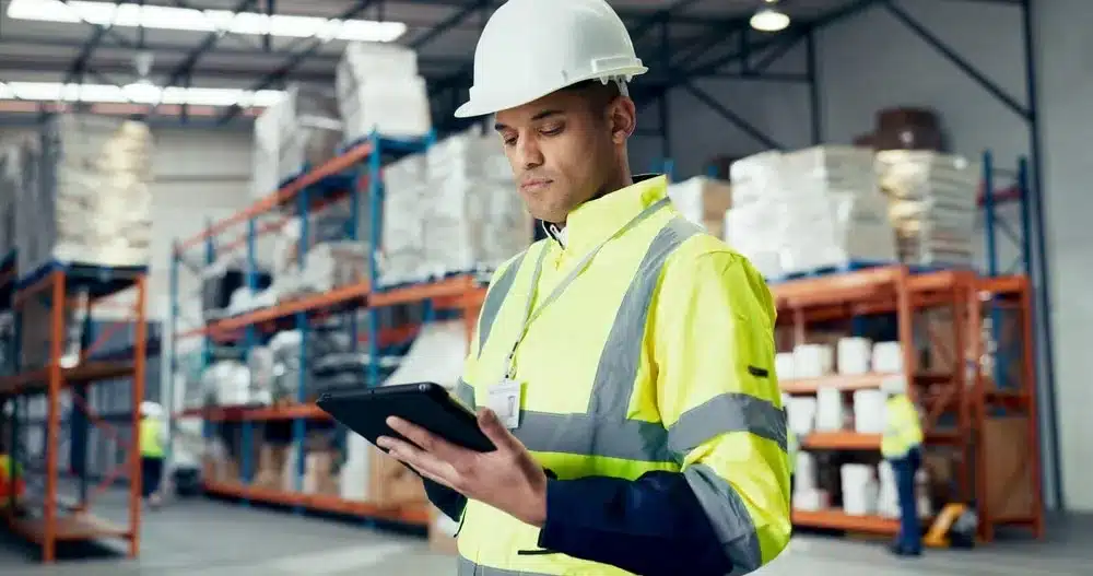 worker viewing warehouse sops on tablet
